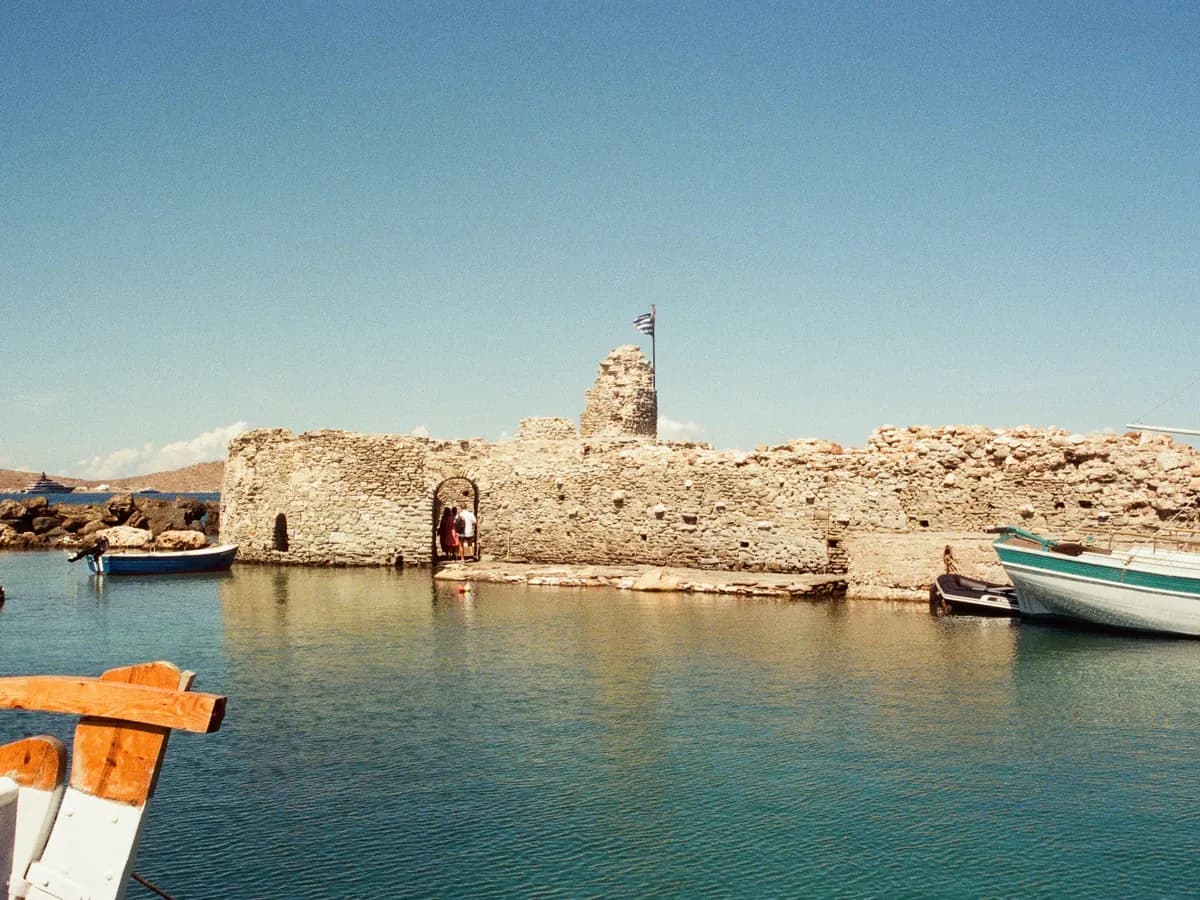 Cyclades: a whitewashed village and a blue-domed church above the Aegean